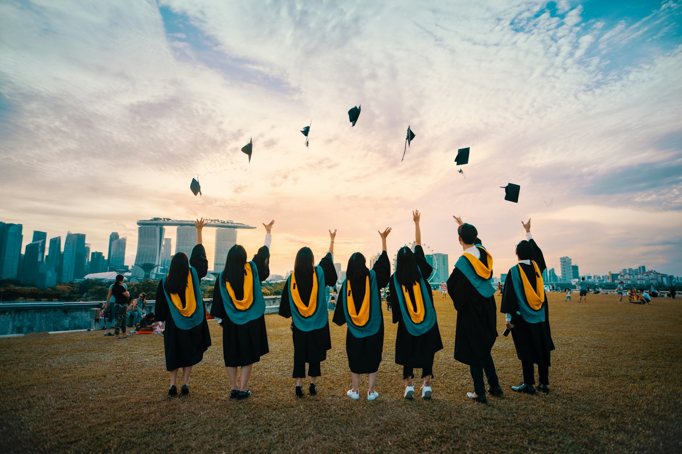 Graduates celebrating success with caps thrown into the air